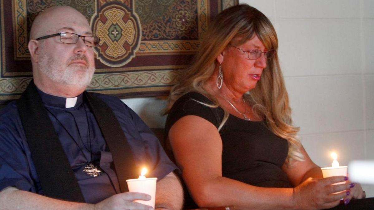 Errol Montgomery Robertson and Molly Kester bow their heads in prayer during a vigil in memory of Dee Whigham at Lighthouse Community Church.