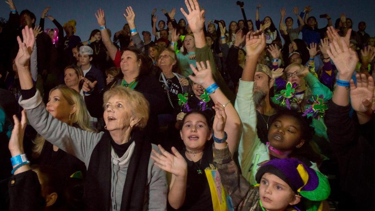 Revelers catch throws at the grandstand during the Krewe of Neptune parade in downtown Biloxi on Feb. 25, 2017.