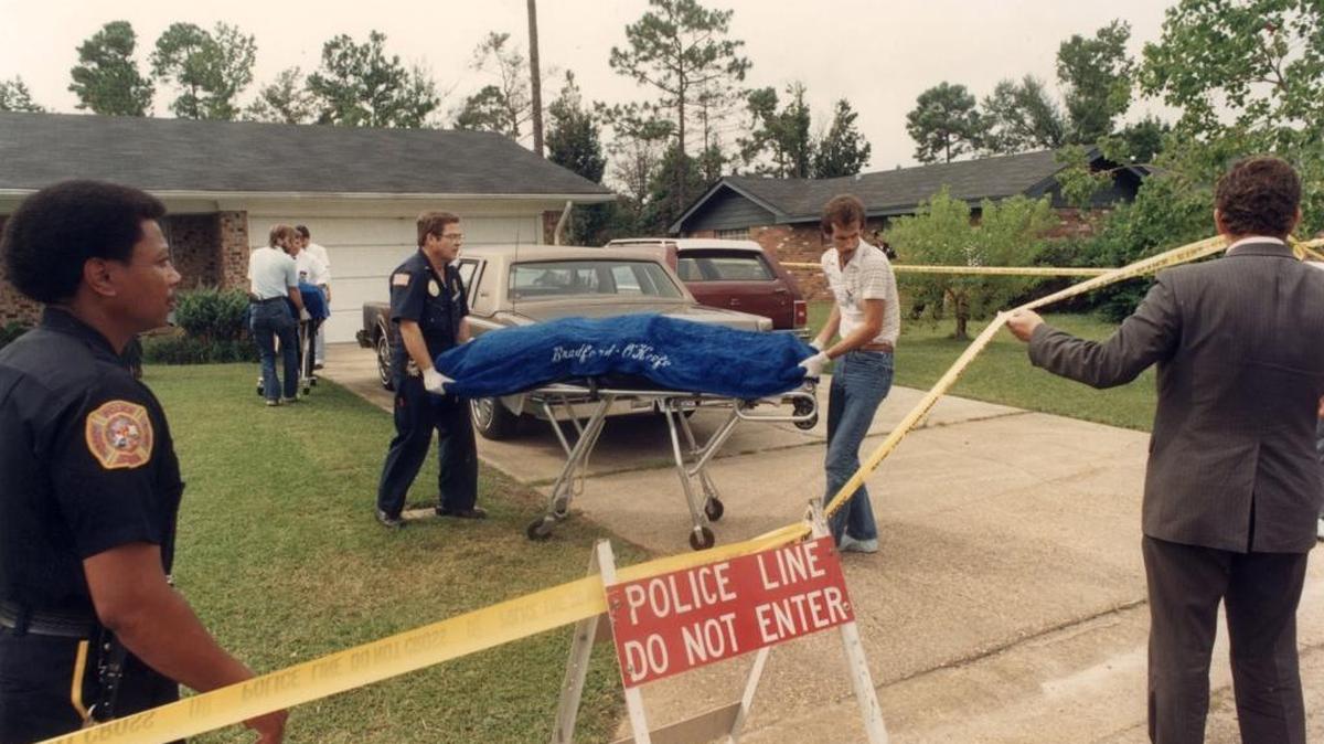 The bodies of Vince and Margaret Sherry are removed from their Biloxi home on September 16. 1987 by Biloxi Police crime scene investigator Robert Burris, center left, and current Harrison County coroner Gary Hargrove ..