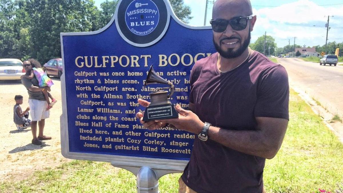 Les Bres singer Lamar Williams Jr. holds his family’s Grammy Lifetime Achievement Award for his time in the Allman Brothers Band.
