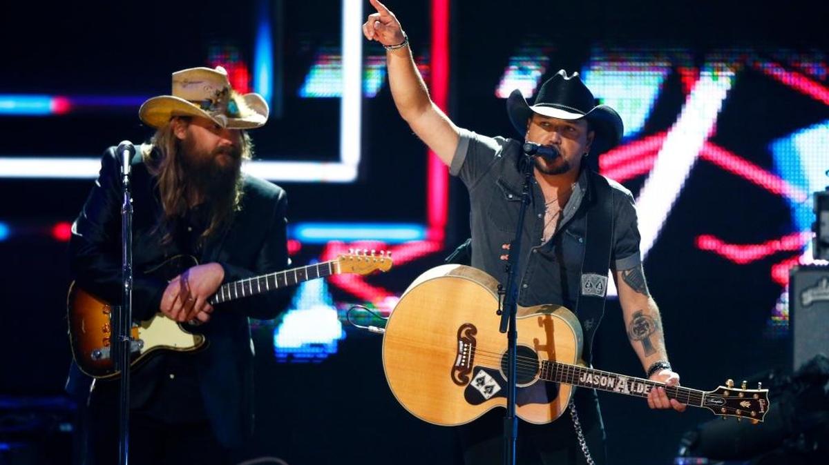 Chris Stapelton, left, and Jason Aldean perform at 2017 CMT Artist of the Year Awards at Nashville's Schermerhorn Symphony Center on Wednesday, Oct. 18, 2017, in Nashville, Tenn.
