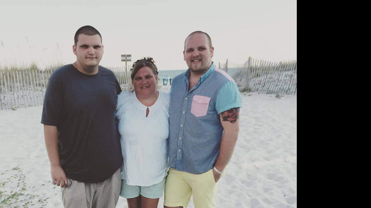 Justin Mitchell, right, with his mother Sissy Mitchell, center, and brother Kyle Moran, left