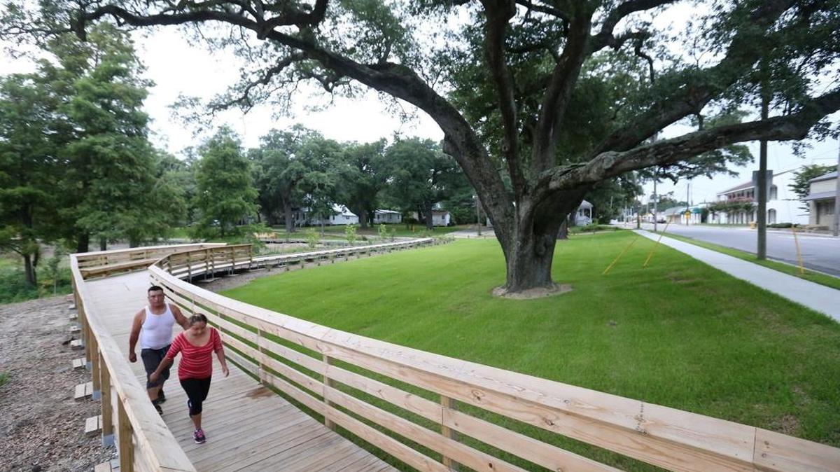 Amanda and Austin Perez of Biloxi walk on the boardwalk at Lighthouse Park in Biloxi on Wednesday, July 1, 2015.