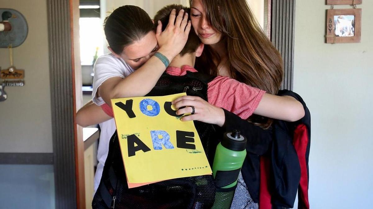 Katrina White, left, James, 12, and Colette White hug after telling James his adoption was approved on Thursday, April 7, 2016, in Gulfport. The couple had been trying to adopt James for more than a year, but as a same-sex couple they faced numerous difficulties.