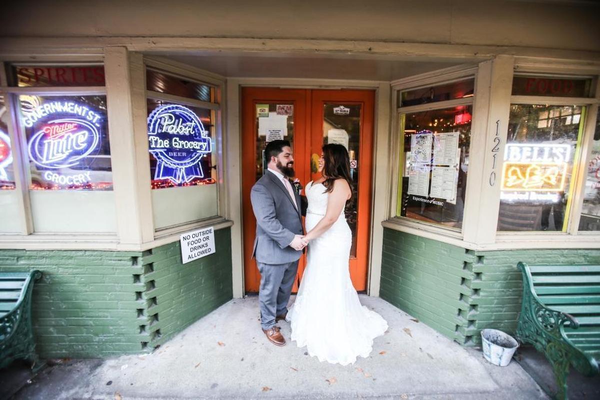 The patio or outside of a bar can provide cool color and fun lighting for a couple's shoot.