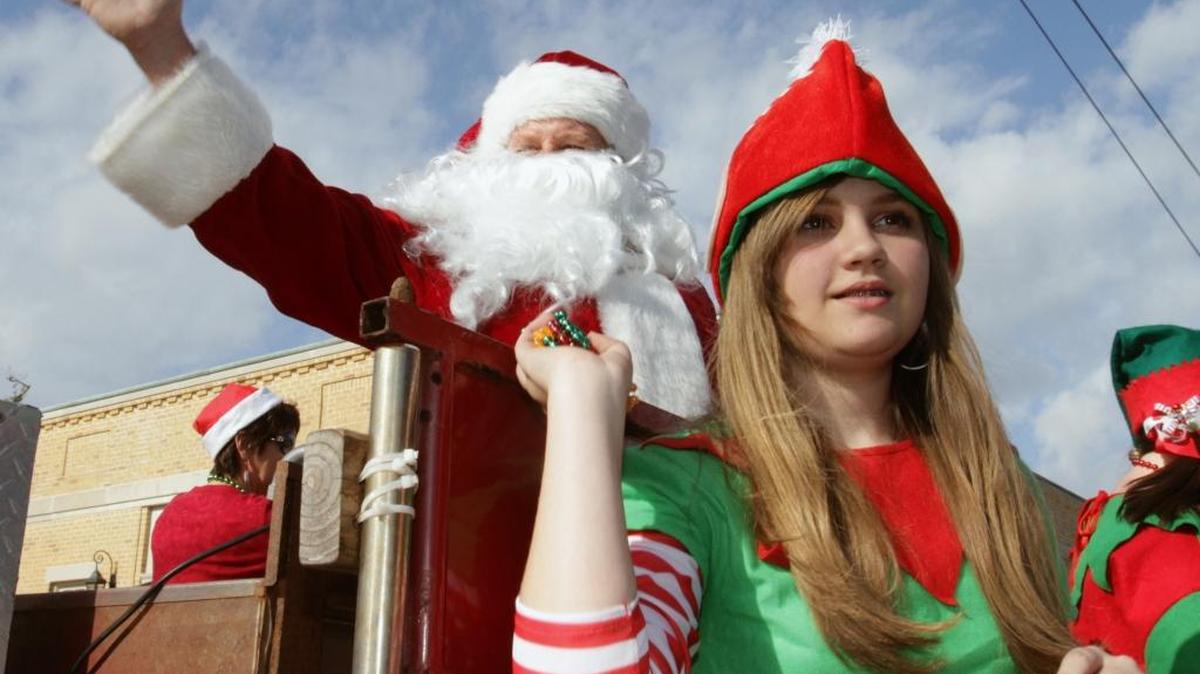 Santa and elf Ashley Borzik of Bay St. Louis ride in the 2012 Bay St. Louis Christmas Parade. Word has it, Santa will be on hand for pictures at the end of Saturday’s Bayside Fire Department’s parade.