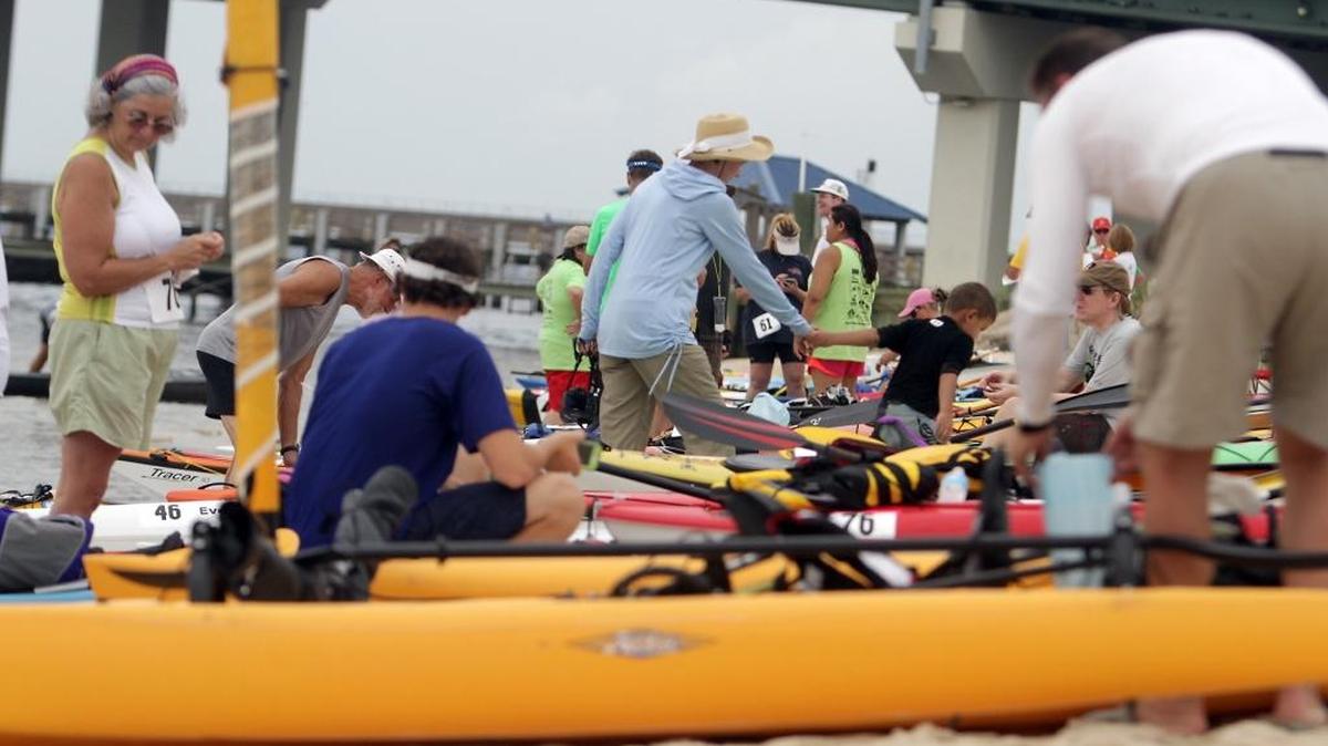 Kayakers prepare for a previous Pink Paddle Kayak Race at the Ocean Springs Yacht Club. The three-mile race, which ends at the Biloxi Yacht Club, benefits the Pink Hearts Fund.