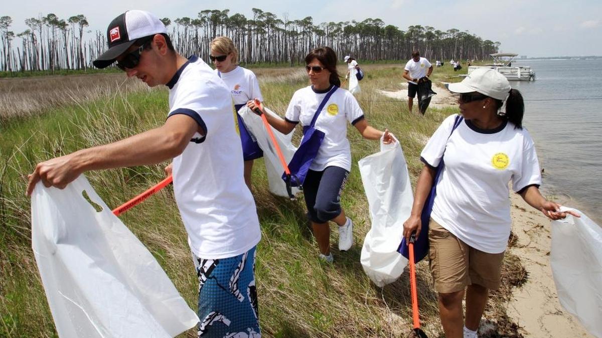Volunteers from Beau Rivage Casino pick up trash on Deer Island for a previous year’s Earth Day project. Several events are planned this week to celebrate Earth Day, encouraging cleanup events and other nature celebrations.