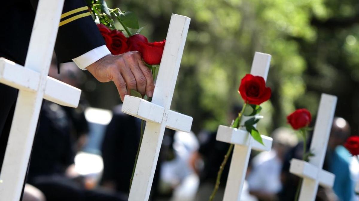 Major Jim Adamo places a rose on a cross for each of the Biloxi Police Department officers that died in the line of duty during the Mississippi Coast Wide Police Appreciation Service in 2014. On Saturday, Aug. 6, at the Jackson County Civic Center, a law enforcement appreciation day will take place.