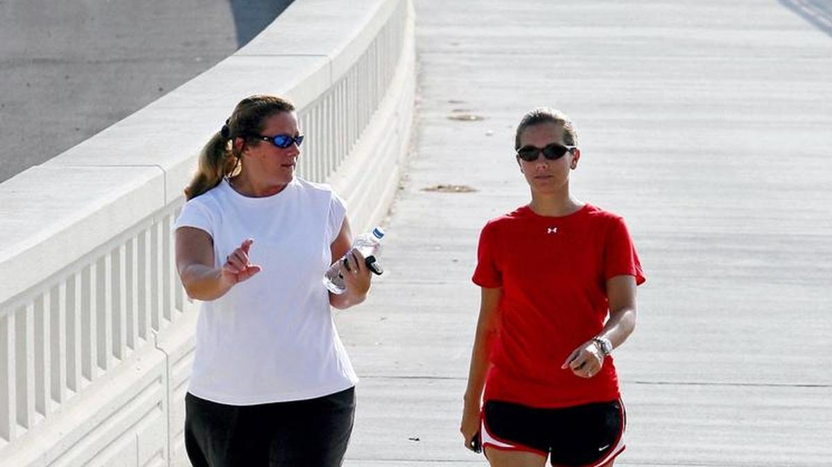 Leah Garner of Ocean Springs, left, and Belinda Gomez of Biloxi walk the Biloxi Bay Bridge during a previous bridge walk and canned food drive. On Saturday, Coast Young Professionals will host Walking on Water: Bridge Walk and Canned Food Drive.