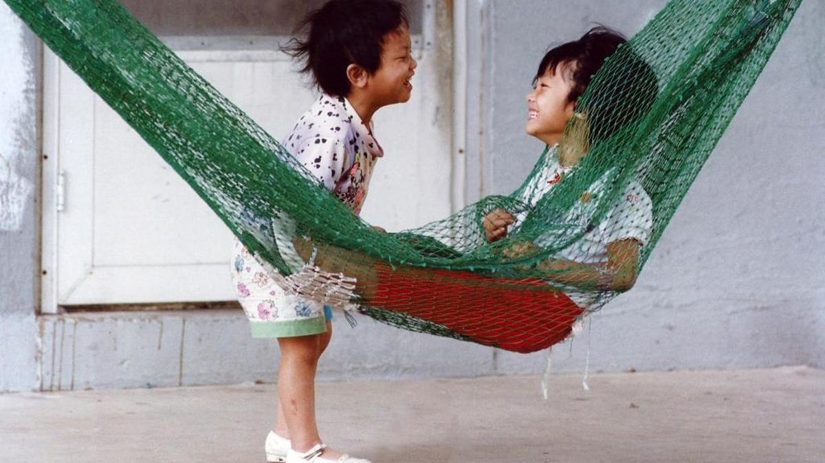 Julia Nguyen and Mai Le play on the front porch of their East End home in Biloxi. The photo is part of ‘The People Within’ exhibit that be rehung at the Ohr-O’Keefe Museum of Art in Biloxi. The opening reception will be from 5 to 7 p.m. Thursday.