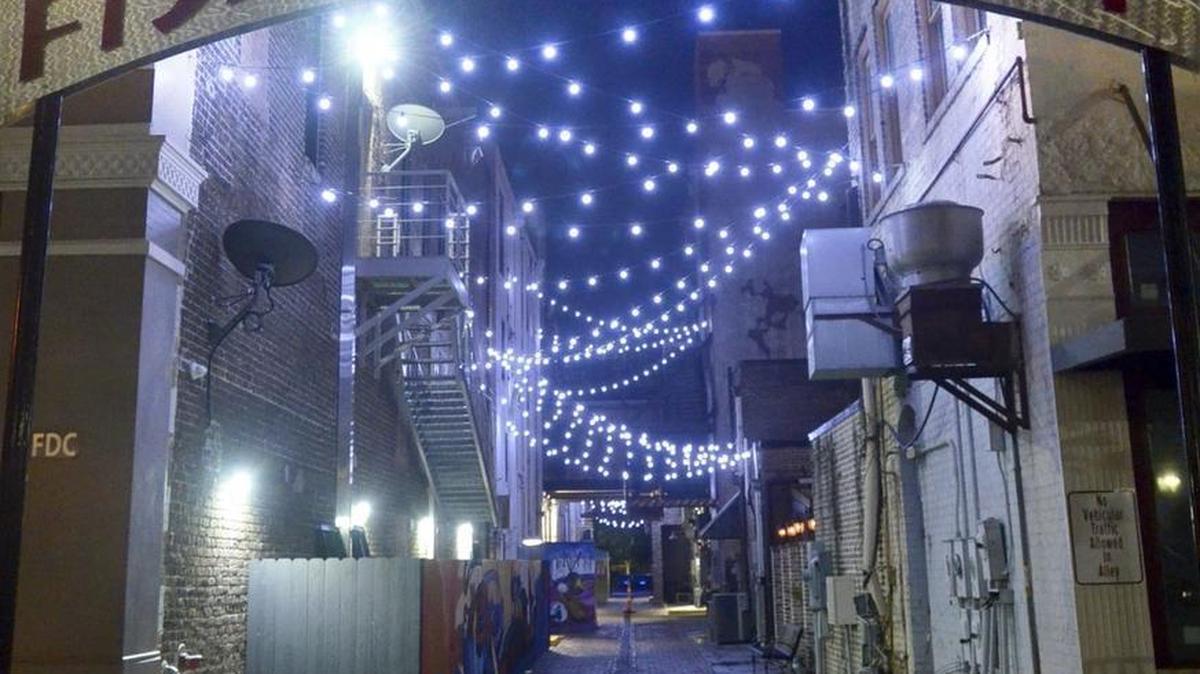 Fishbone Alley, a pedestrian walkway that links 17 bars and restaurants, lights up the downtown entertainment district in Gulfport.