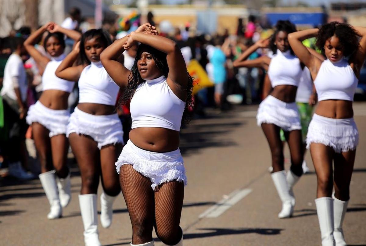 The Pretty Boyz and Pretty Girlz dance team walks down U.S. 49 during the Krewe of Gemini parade on Saturday, February 25, 2017.