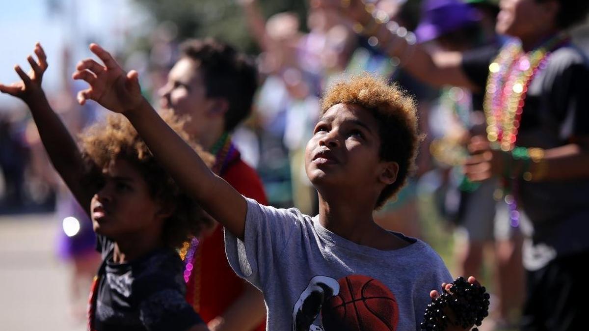 Zayveon Tucker, 9, tries to catch some beads while watching the 50th annual Nereids parade on Saturday, February 19, 22017, in Waveland.