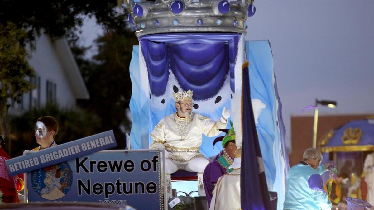 Krewe of Neptune King Rich Moss throws beads to the crowd as the parade rolls in downtown Biloxi on Saturday, February 6, 2016. Floats for this year’s parade will travel from New Orleans to Biloxi on Tuesday.