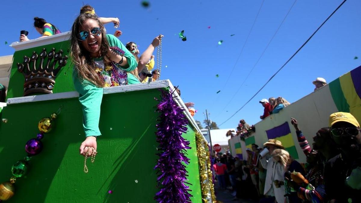 Float riders throw beads and confetti during the St. Paul Carnival Association parade in downtown Pass Christian on Sunday, February 26, 2017. "Pass Beyond Galaxies: An Outer Space Adventure" was this year's theme.