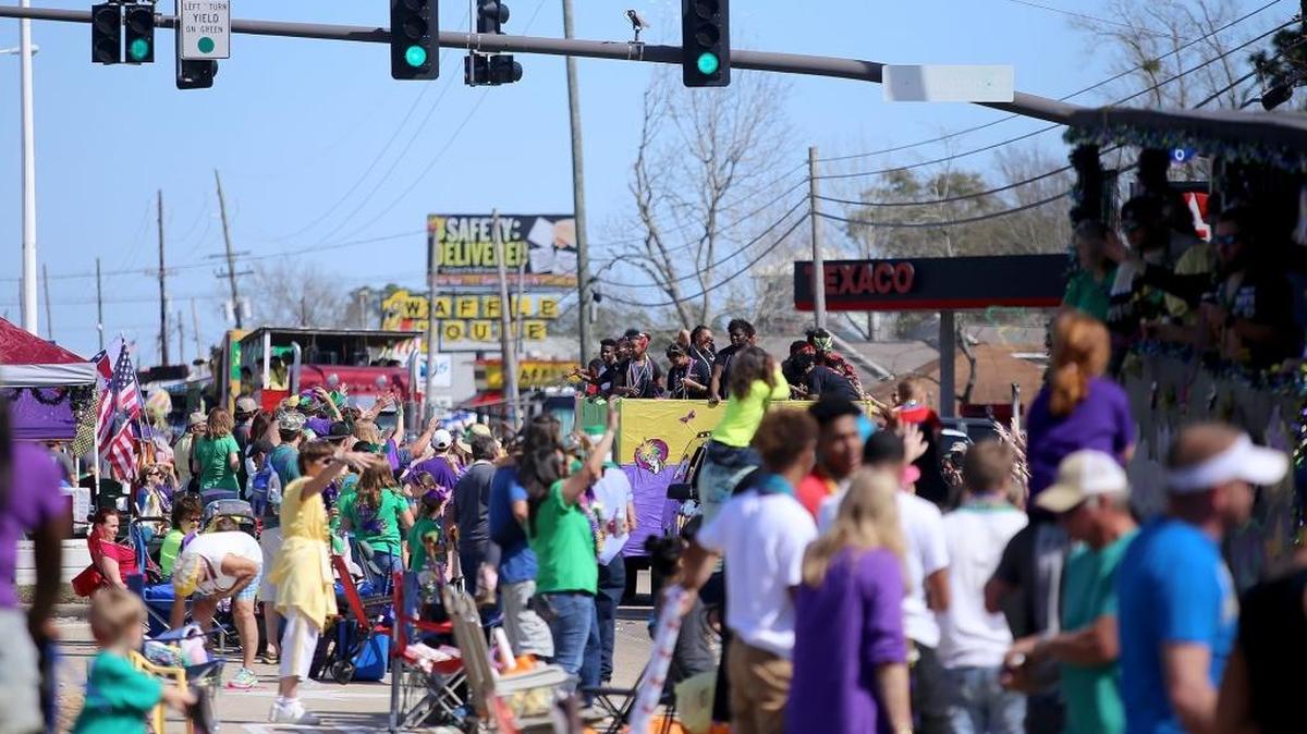 The crowd cheers for throws as the 50th annual Nereids parade rolls down U.S. 90 on Sunday, February 19, 2017, in Waveland.