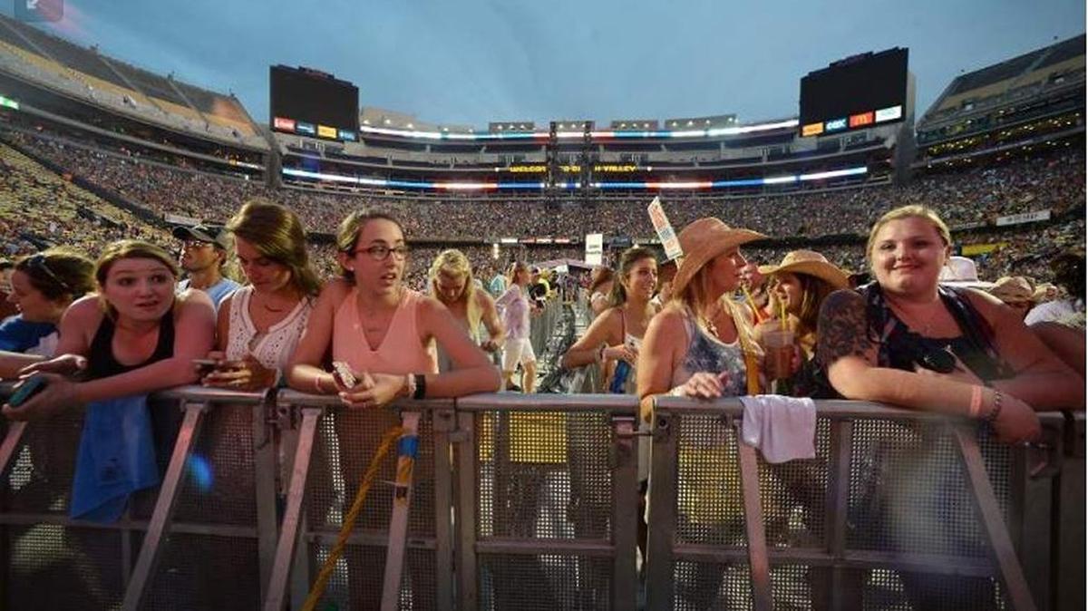 Fans rest on barricades before Dierks Bentley performs during the Bayou County Superfest in 2016 at LSU’s Tiger Stadium in Baton Rouge. The concert festival is moving to the Superdome in 2017.