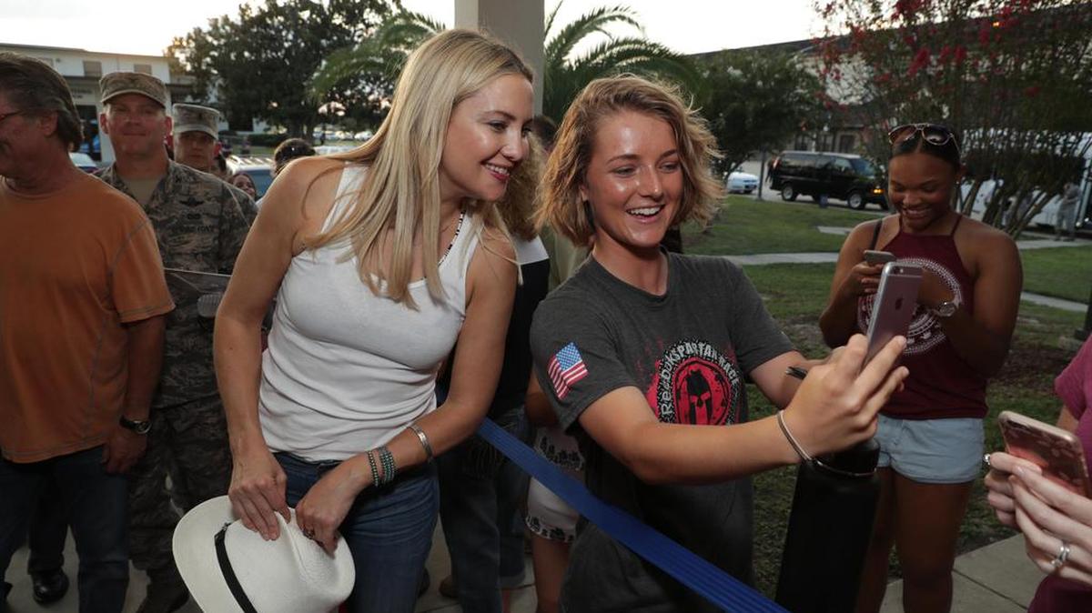 Kate Hudson, one of the stars of “Deepwater Horizon” poses for a photo with a fan during a recent visit to Keesler Air Force Base in Biloxi. The film opens in theaters Friday.