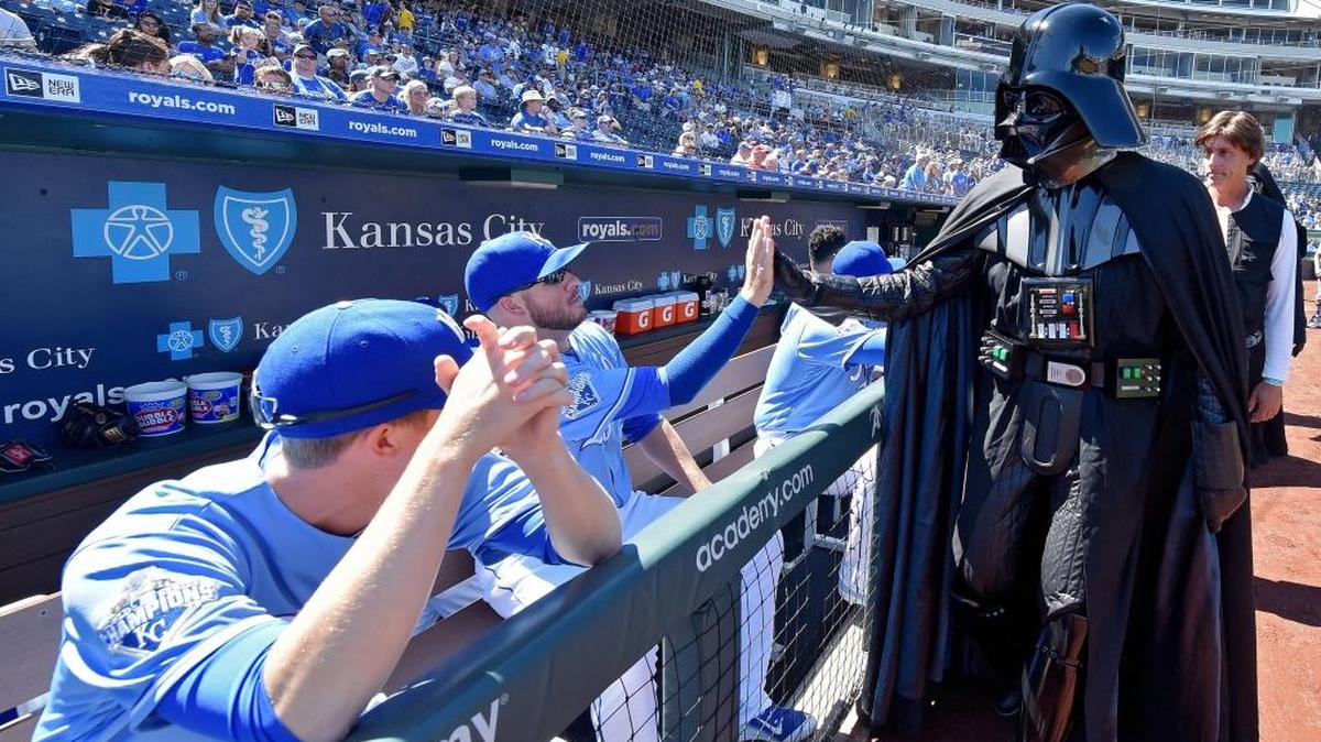 Kansas City Royals players high five Darth Vader as he walks off the field before the baseball game against the Chicago White Sox on Sunday, Sept. 18, 2016 at Kauffman Stadium in Kansas City, Mo.