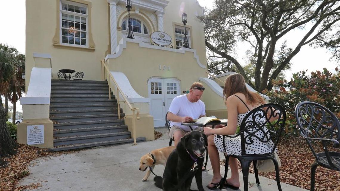 Mary Teske and Matt Hudson of Minneapolis, MN., and their dogs, Dixie and Chip, sit outside Le Cafe Beignet on Monday, March 5, 2018, as they explore South Mississippi.