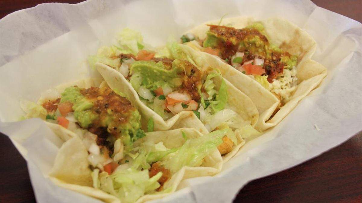Overstuffed pork tacos are a hit.