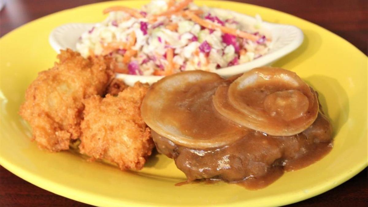 Lancaster’s Thursday lunch special is a housemade hamburger steak served here with a side of cole slaw and hushpuppies.