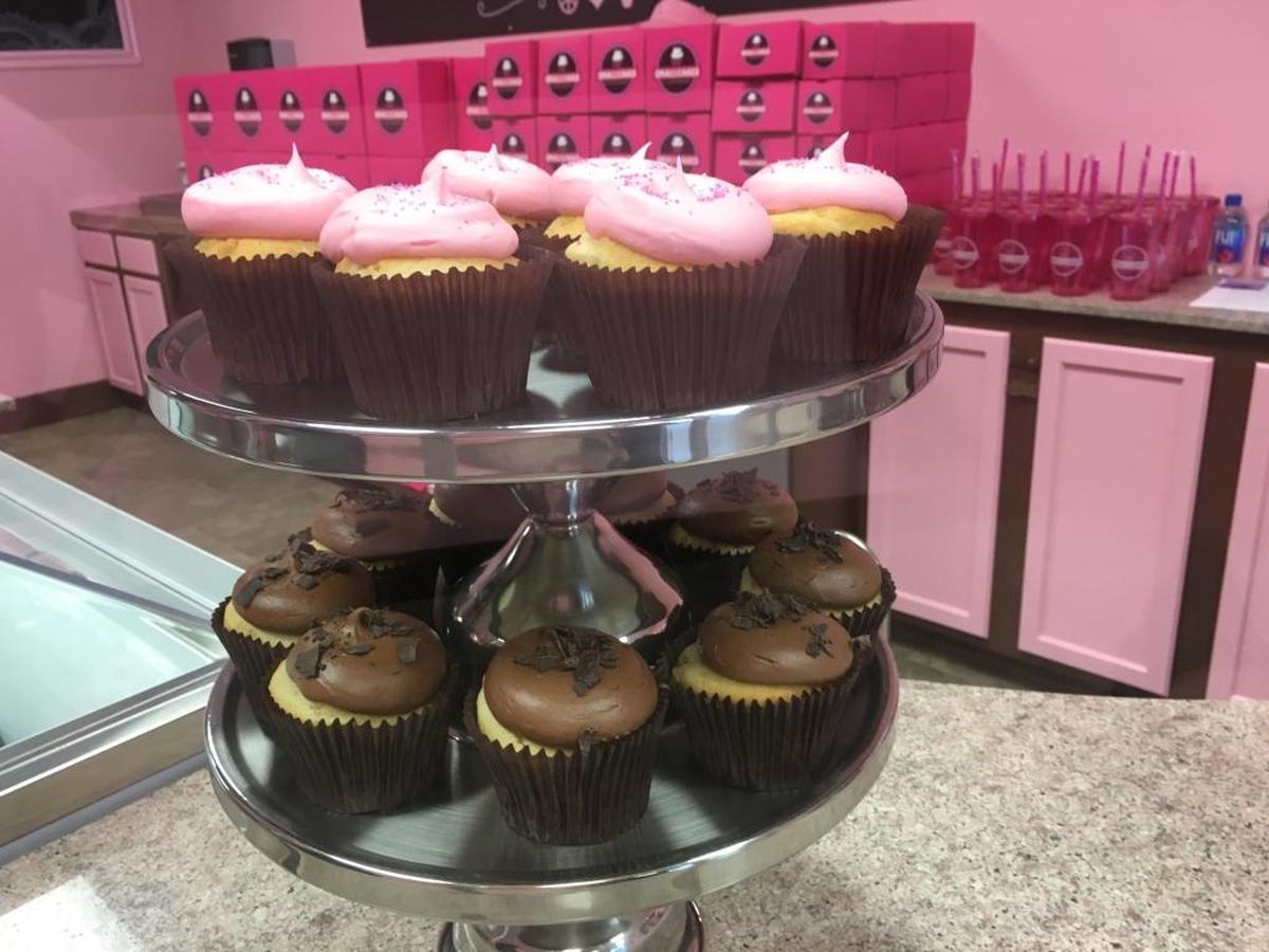 Pink Vanilla and chocolate cupcakes await customers.