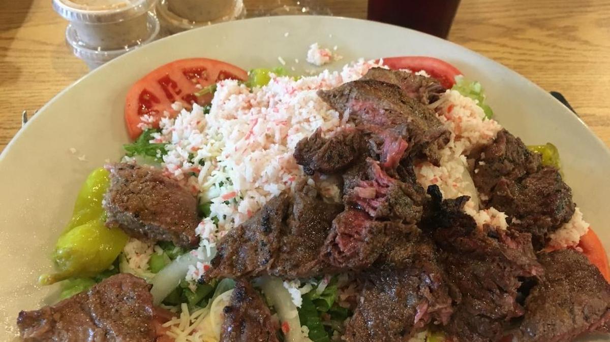 The Ribeye Salad at Captain Al’s in Gulfport is an 8-ounce ribeye steak diced and served over a garden salad. For a little more, you can have crab added.