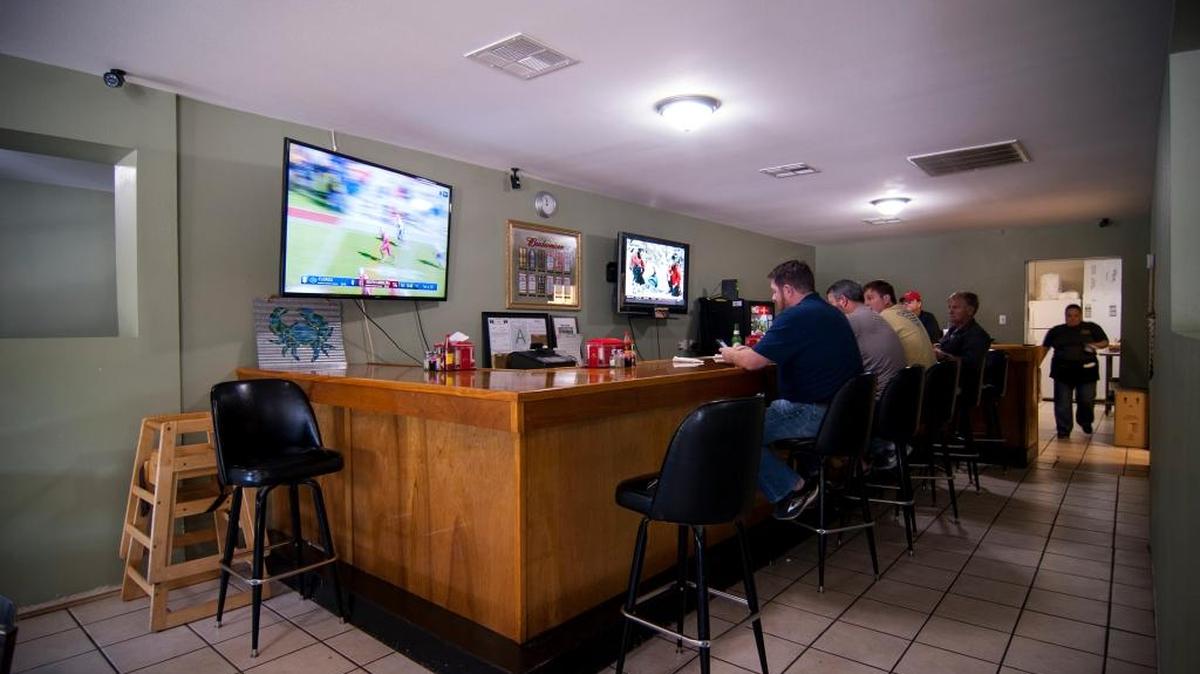 Interior: Regulars sip beer and watch football on a Saturday morning.