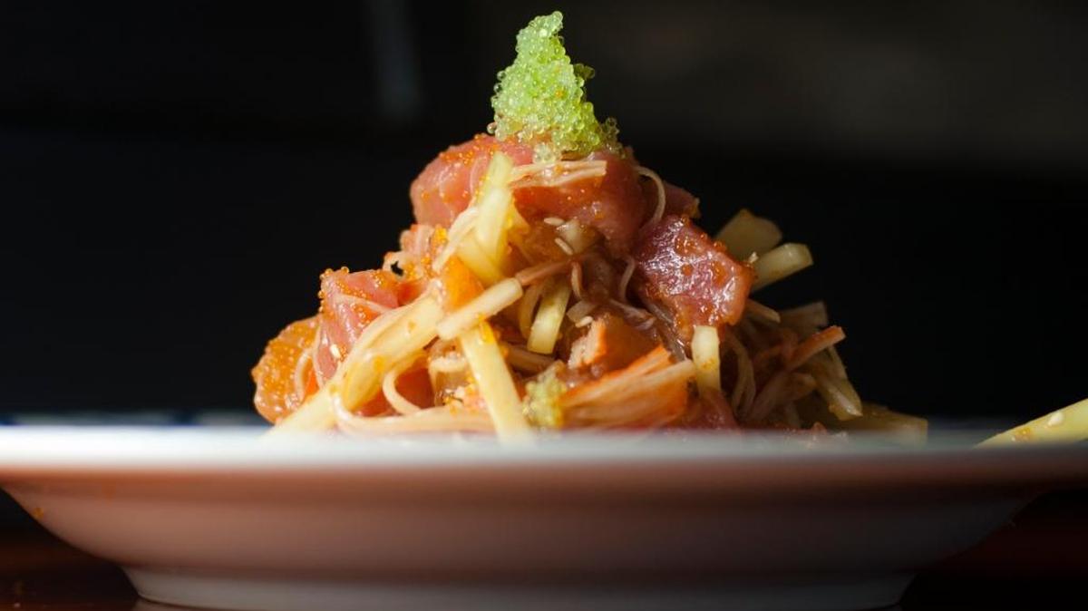 The seafood salad is a mix of cucumber, imitation crab, and tender raw salmon, tuna, yellowtail and snapper. It comes garnished with a tower of flying fish roe.