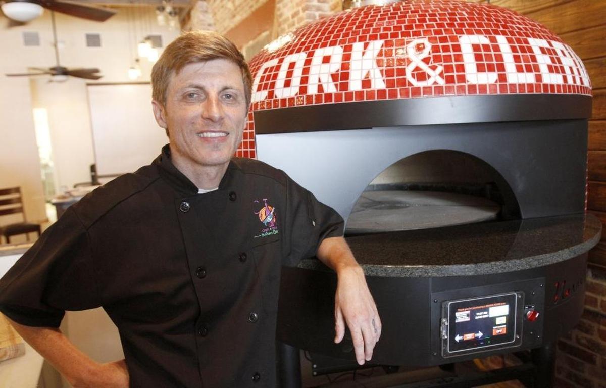 David Dickensauge stands by his brick oven at his Corks & Cleaver Italian Bistro in Bay St. Louis. He is returning to South Mississippi to open a new restaurant in downtown Biloxi.