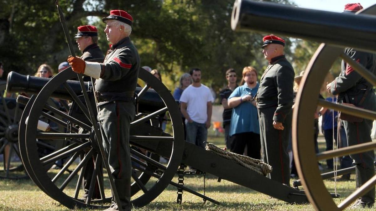 Confederate artillery stand ready while demonstrating how to load and fire a Civil War-era cannon during a past Fall Muster at Beauvoir