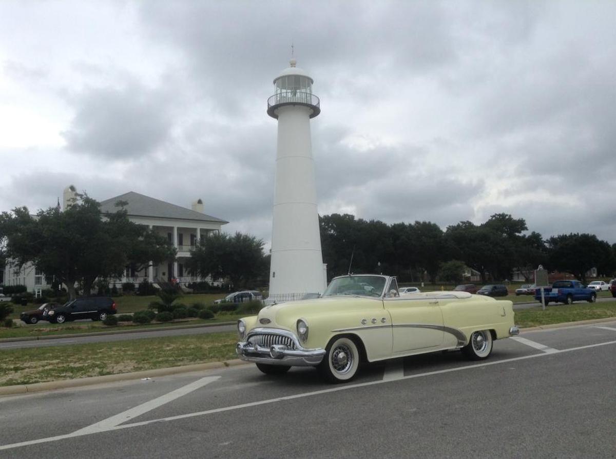 A classic 1950s Buick is parked in sight of the highly photographed Biloxi Lighthouse on Beach Boulevard.