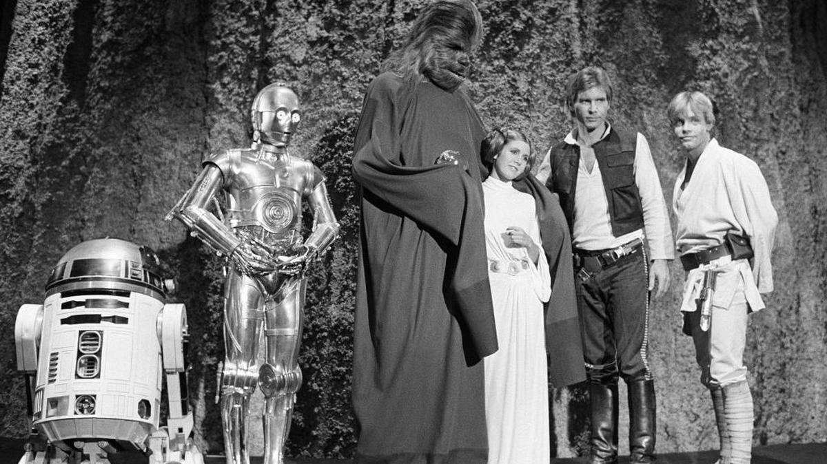 In this Nov. 13, 1978 file photo, shows, from left, Kenny Baker, Anthony Daniels, Peter Mayhew, Carrie Fisher, Harrison Ford, and Mark Hamill during the filming of the CBS-TV special ‘The Star Wars Holiday’ in Los Angeles.