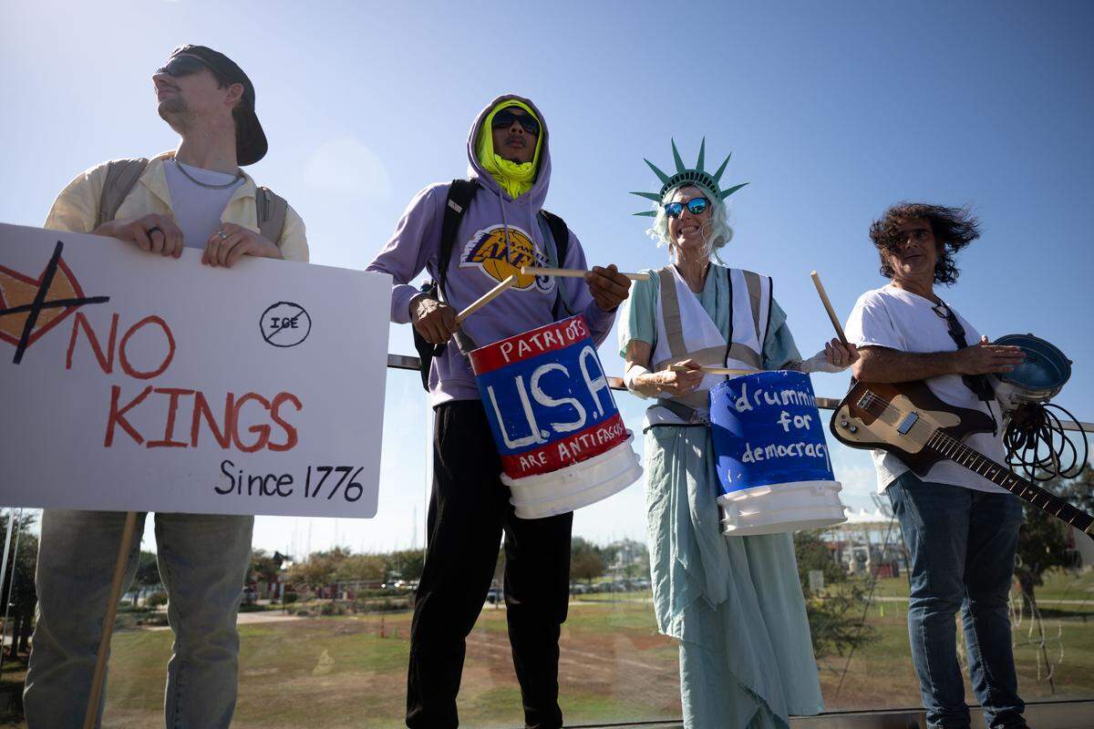 Protesters beat their drums as they march Saturday in Gulfport.