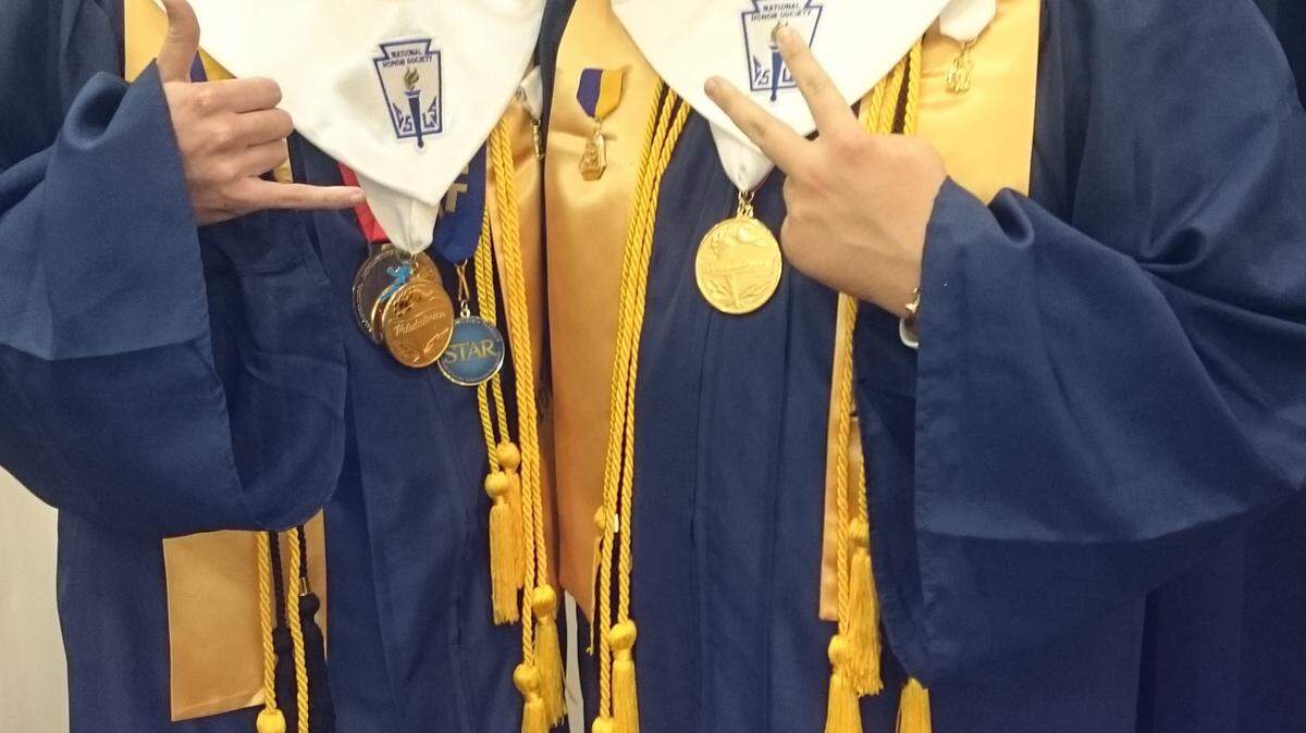Gautier High School valedictorian Cameron Tingle, left, and salutatorian Joshua Thweatt pause during the graduation ceremony Fridy night, May 20, 2016, at Gautier's Vaughn-Wallace Stadium.
