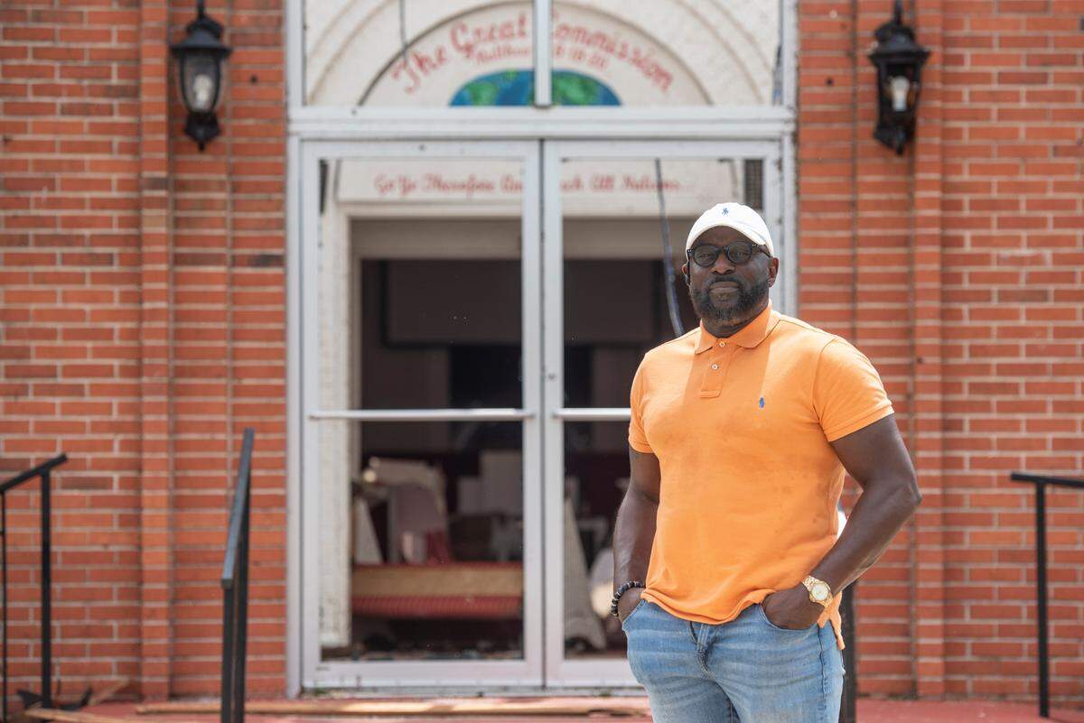 Pastor Kevin L. Henry Sr. poses for a portrait outside of First Baptist Missionary Church in Moss Point on Tuesday, June 20, 2023, after a tornado tore the roof off the building on Monday.