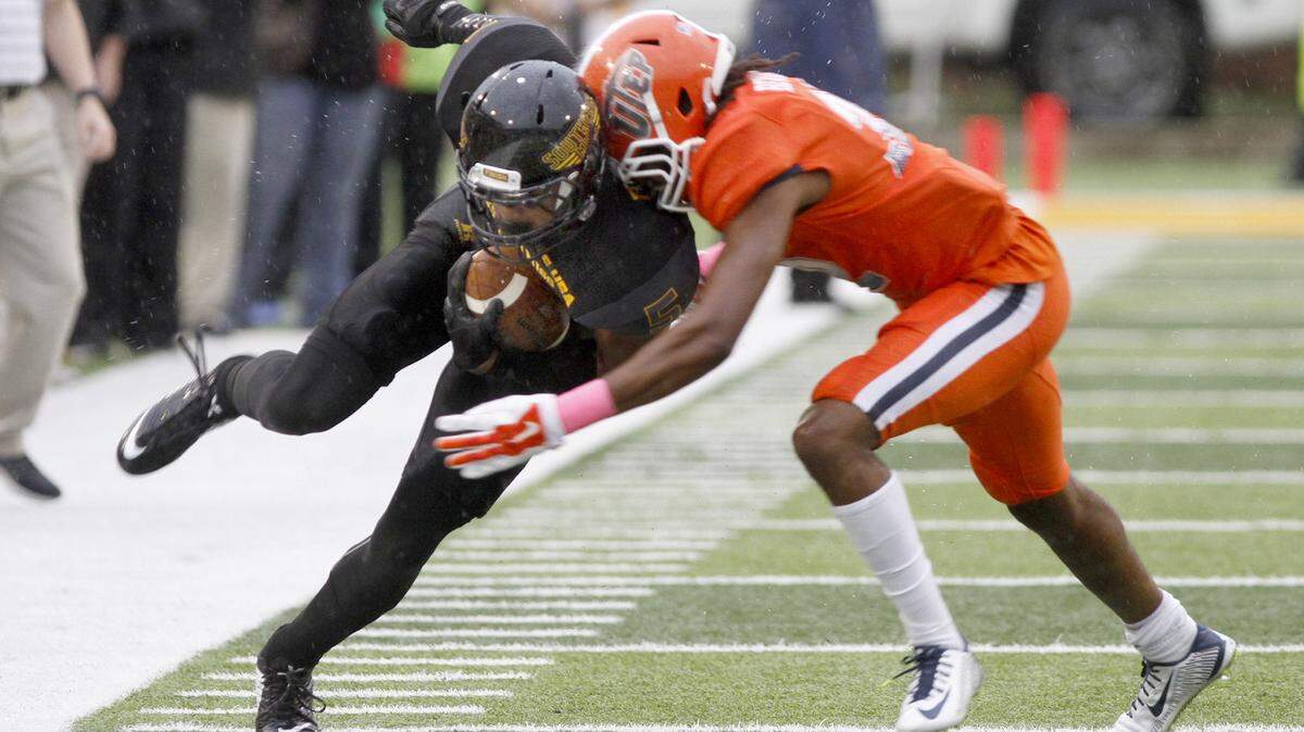 TIM ISBELL/SUN HERALD 
Southern Miss receiver D. J. Thompson tight ropes the sideline as he is brought down by a UTEP defender on Oct. 31, 2015.