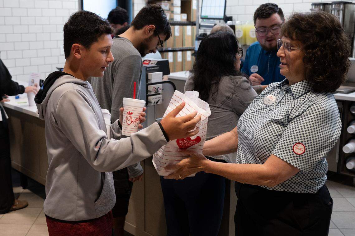 Sebastian Cooper, left, receives the first order at the new Chick-fil-A in Ocean Springs.