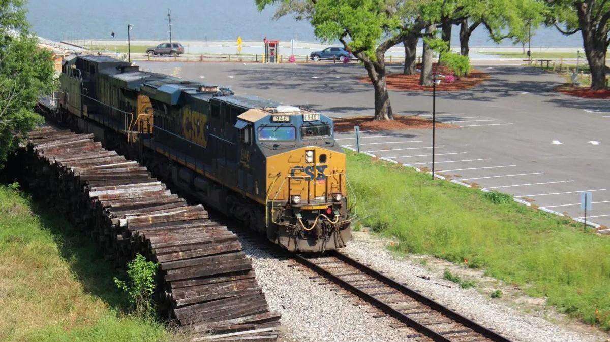 A CSX Transport freight train passes through Bay St. Louis along tracks that could one day host an Amtrak passenger route. Credit: Sara DiNatale/Mississippi Today