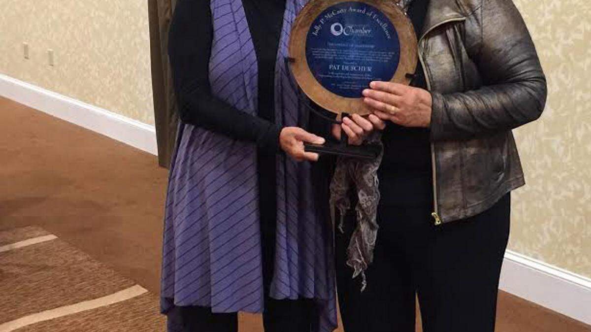 JEFF CLARK/SPECIAL TO THE SUN HERALDEvelyn McCarty, left, presents the Jolly P. McCarty Award of Excellence in Leadership to Pat Drescher of Gautier.