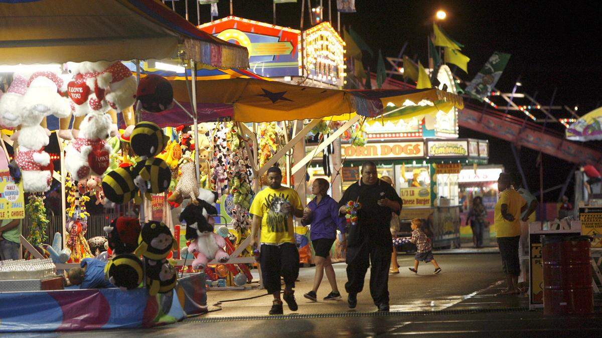 TIM ISBELL/SUN HERALD/FILEPeople enjoy the midway of the Summer Fair at the Coast Coliseum in Biloxi. This year's event is open through Sunday.