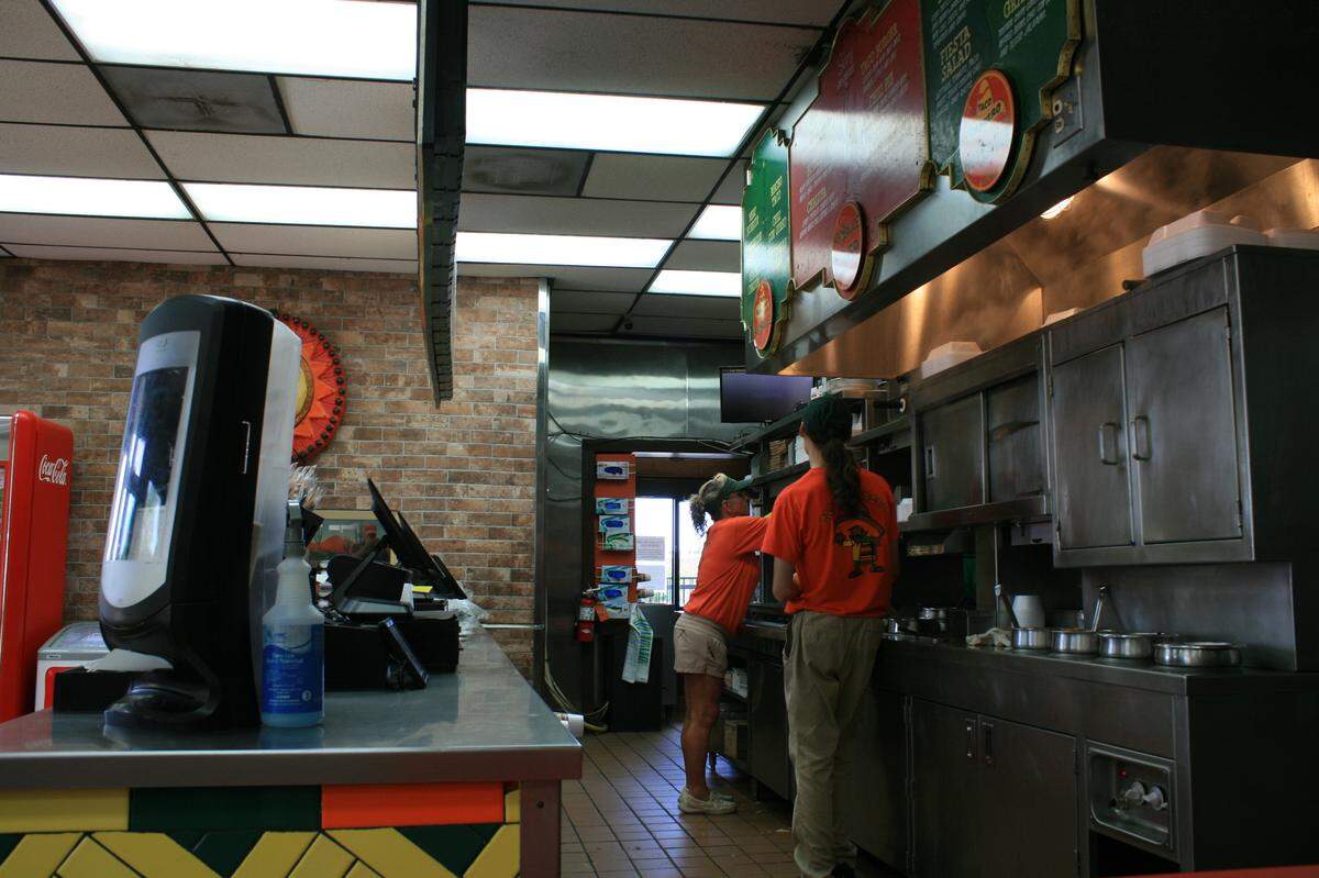 Employees perform their duties inside Gulfport’s Taco Sombrero.