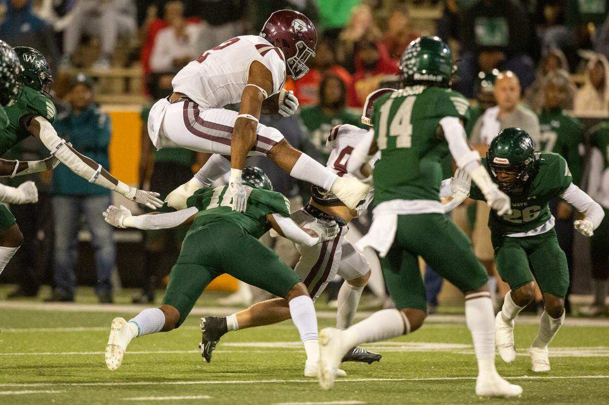 Picayune’s Dante Dowdell jumps over West Point’s Matthew Shirley during the 5A State Championship at M.M. Roberts Stadium in Hattiesburg on Friday, Dec. 2, 2022.