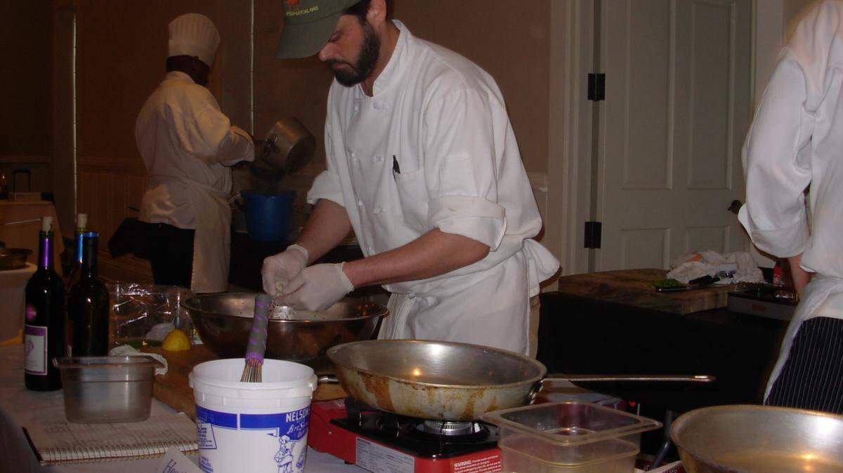 TAMMY SMITH/SUN HERALD 
 Heath Johnson of Oxford prepares a dish for the Mississippi Seafood Cookoff in Biloxi in 2011. The 7th Seafood Cookoff will blend with food, drink and entertainment to become the Mississippi Seafood Experience May 26 in Gulfport.