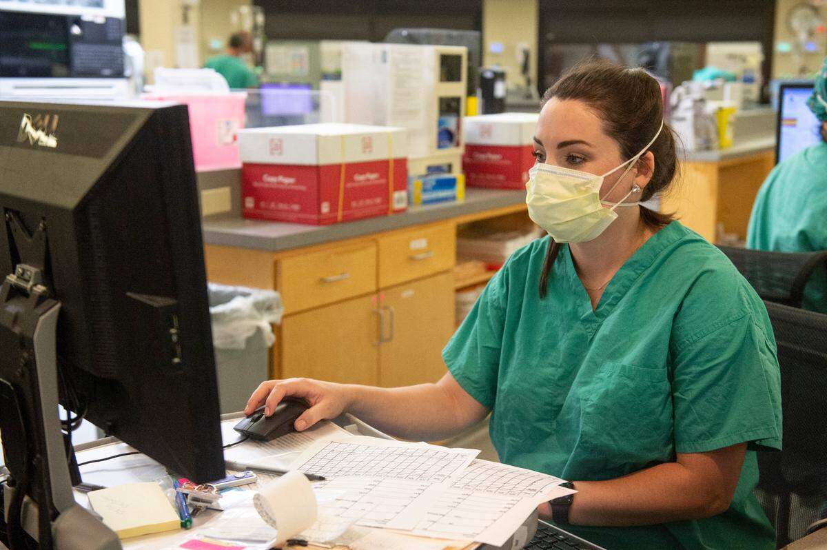 A nurse works on a computer inside the ICU at Singing River Health System hospital in Ocean Springs on Tuesday, July 27, 2021.