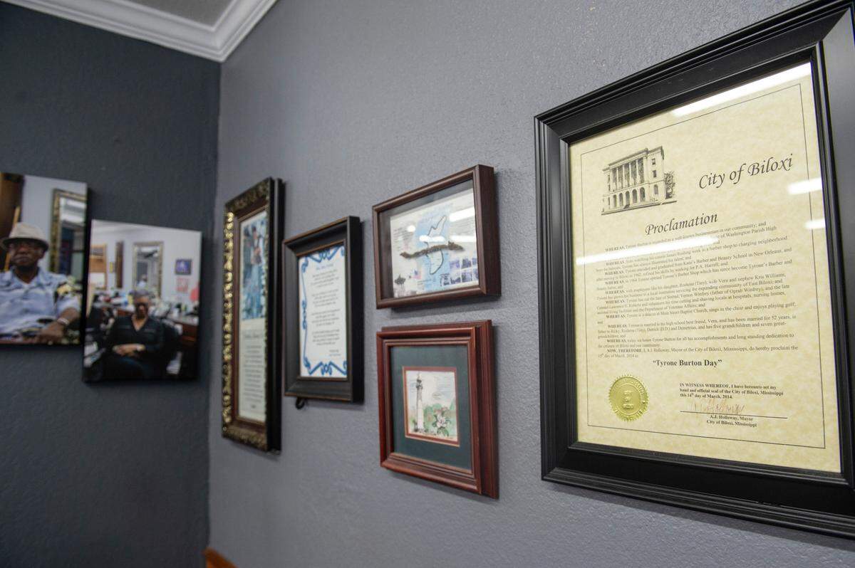 A city proclamation for Tyrone Burton Day and other photos and memorabilia line the walls of Tyrone Burton’s barbershop in Biloxi on Wednesday, May 21, 2025. Burton, who has been a barber in Biloxi for 64 years will have a section of Main Street named for him.