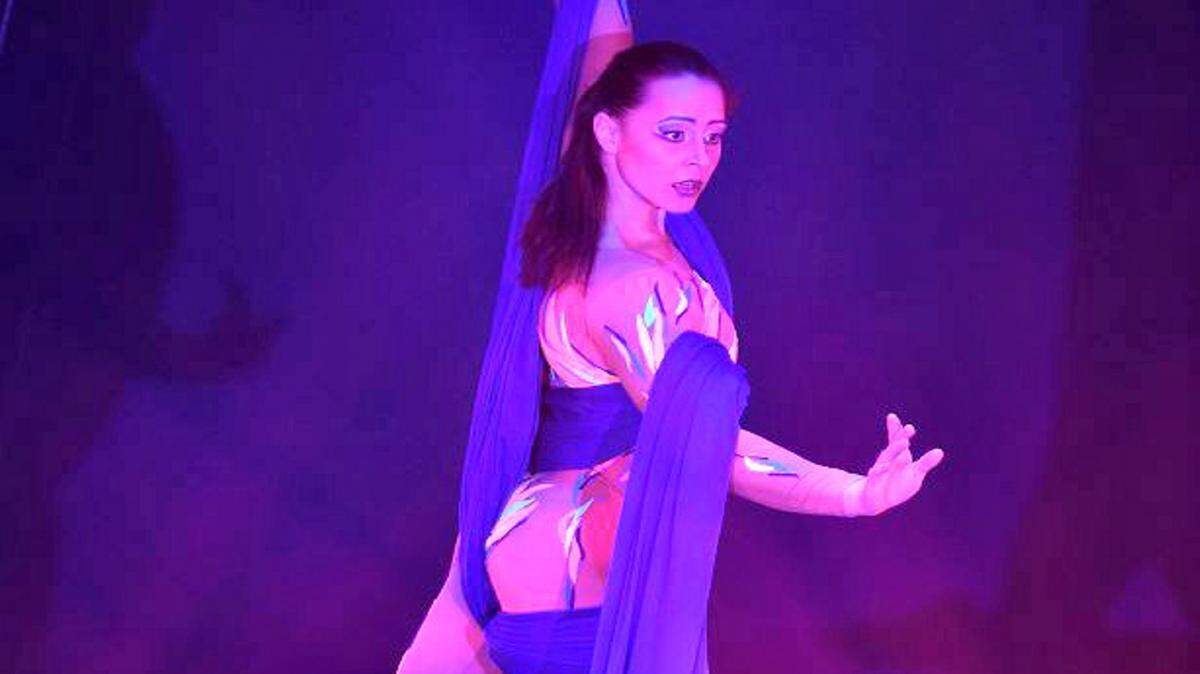 PHOTO COURTESY OF BEAU RIVAGEA performer in BraVeau, this summer's new DreamCast Entertainment show at the Beau Rivage Resort and Casino in Biloxi, will use long silks to twirl above the crowd. A display high in the atrium at the Beau Rivage promotes the show and has visitors looking up to see if they are real performers above their heads.