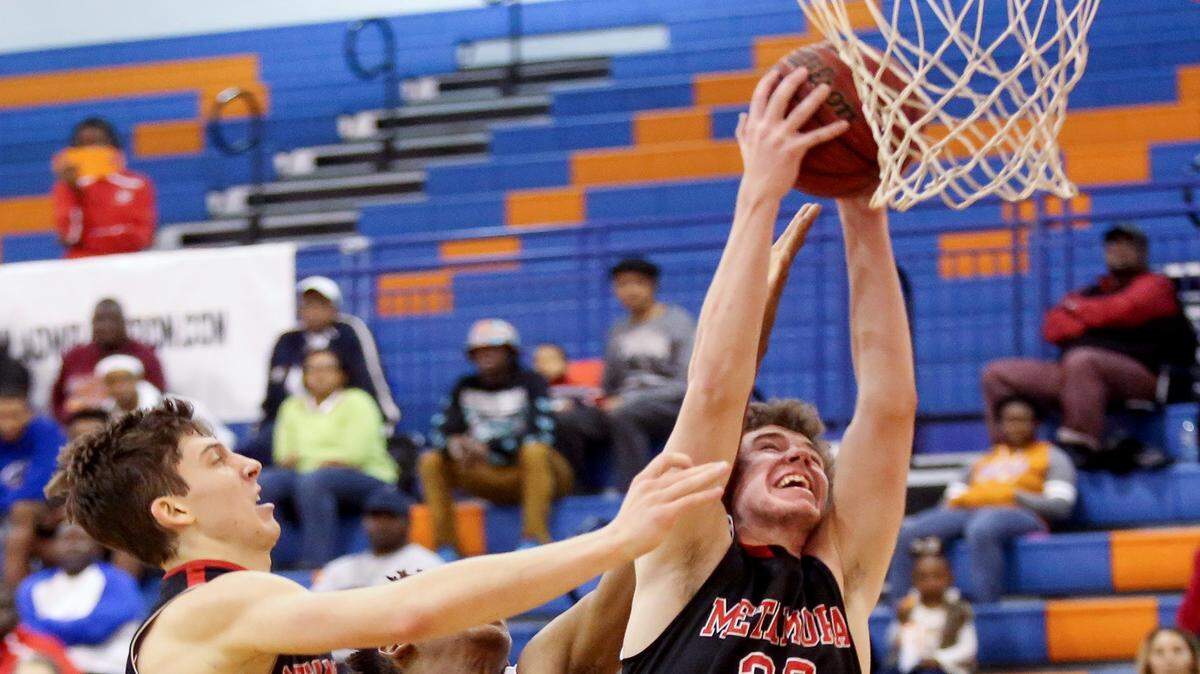 AMANDA McCOY/SUN HERALD 
 Metamora's Jordan Dehm, right, snags the rebound from Biloxi's Marques McGee, center, and teammate Miachel Adams during the Gulfport Hardwood Holiday Classic on Tuesday, December 29, 2015.